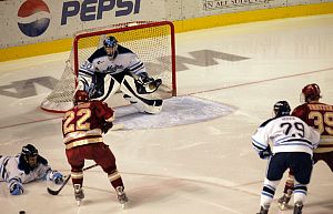 DU's Brian Gifford (22) loses the puck en route to Maine's Ben Bishop.