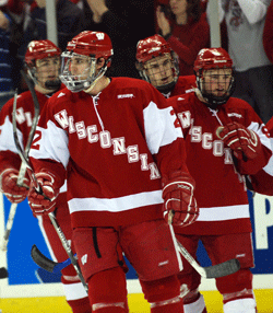 Jamie McBain leads the Wisconsin power play off the ice after scoring Saturday (photo: Tim Brule).