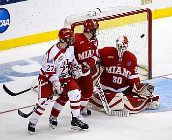 Colby Cohen's winning goal floats over the shoulder of Cody Reichard to give Boston University the title (photo: Jim Rosvold).