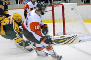 RIT's Jess Newman (10) beats Paul Karpowich to give the Tigers a 2-0 first period lead (photos: Angelo Lisuzzo).