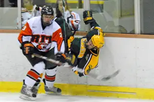 RIT's Justin Hofstetter (3) levels a Clarkson Golden Knight.