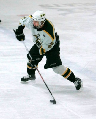 St Norbert defenseman Mike Bernardy gets off a shot in Wednesday's 4-3 first round win over Adrian (photo: SNC athletics).