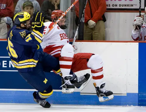 Ben Winnett takes down Eric Gryba in front of the BU bench (photo: Melissa Wade).