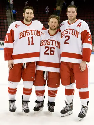 BU seniors pose together postgame: Zach Cohen (11), Luke Popko (26) and Eric Gryba (2) (photo: Melissa Wade).