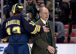 University of Michigan captain Carl Hagelin congratulates Spartan coach Rick Comley on his win. (Erica Treais)