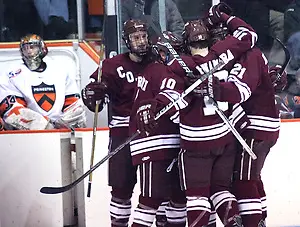 Colgate's Robbie (Colgate - 17) Bourdon celebrates his third period goal with teammates, as the Colgate Raiders cut the Princeton lead to 5-4. (Shelley M. Szwast)