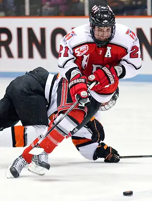 Chase Polacek (RPI - 21) plays the puck through the neutral zone. Polacek had a goal and two assists as Rennselaer defeated Princeton 5-2. (Shelley M. Szwast)