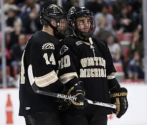 Western Michigan captain Ian Slater (14) chats with teammate J.J. Crew during a timeout in the second period of the CCHA Championship game at Joe Louis Arena in Detroit, Michigan on March 19, 2011. (Rena Laverty)