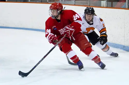 Hayleigh Cudmore (Cornell -24) plays the puck away from Cristin Shanahan (Princeton -19). (Shelley M. Szwast)