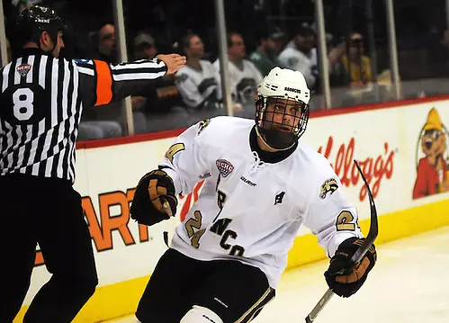 Shane Berschbach skates to his teammates after tying the game 2-2 with Denver. (Jordan Doffing)